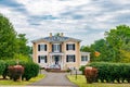 traditional American house in colonial style. Two floors, veranda and fountain in front yard