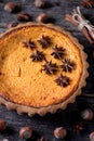 Traditional American pumpkin pie with spices on an old wooden background. Royalty Free Stock Photo