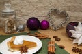 Traditional american pumpkin pie with whipped cream, brown cane sugar. Heart decoration, violet christmas balls and brown sugar. Royalty Free Stock Photo