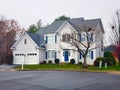 Traditional American residential house. Perfect neighbourhood in suburb, in North America. Luxury houses with nice landscapes Royalty Free Stock Photo