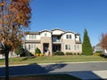 Traditional American residential house. Perfect neighbourhood in suburb, in North America. Luxury houses with nice landscapes Royalty Free Stock Photo