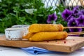 Traditional American street food corn dogs with mustard and ketchup on wooden table. Royalty Free Stock Photo