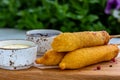 Traditional American street food corn dogs with mustard and ketchup on wooden table. Royalty Free Stock Photo