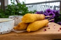 Traditional American street food corn dogs with mustard and ketchup on wooden table. Royalty Free Stock Photo