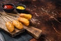 Traditional American street junk food Deep fried corn dogs with mustard and ketchup. Dark background. Top view. Copy Royalty Free Stock Photo