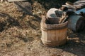 Traditional ancient russian wooden water bucket stands on the ground in summer, selective focus. Royalty Free Stock Photo