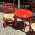 Traditional chair and table of Andalusia painted red and decorated with flowers. Spain Royalty Free Stock Photo