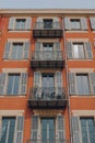 Traditional apartment block building with shutters on windows in Nice, France