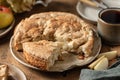 Traditional apple pie charlotte sprinkled with cinnamon with tea on wooden background close up. Tea time with apple Royalty Free Stock Photo