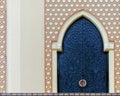 Traditional arabesque pattern on the wall, arched iron door with decorative ornament