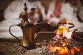 Traditional arabic coffee pot named dallah in fireplace Royalty Free Stock Photo