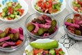 Traditional Arabic green salad with slices of cucumber and tomatoes mixed together and a green chili pepper and marinated Royalty Free Stock Photo