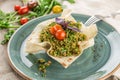 Traditional Arabic Salad Tabbouleh with couscous, tomato and greens in lavash bread bowl on wooden table Royalty Free Stock Photo