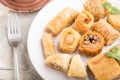 Traditional arabic sweets kunafa, baklava and a cup of coffee on a white wooden background. side view, selective focus