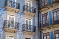 Traditional architecture of buildings with tiles in Porto Portugal. Blue facades with windows and balcony