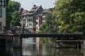 Traditional architecture and metallic bridge on Rhine river at little France quarter in Strasbourg