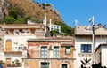 Traditional architecture of Sicily in Italy, typical street of Taormina, facade of old buildings Royalty Free Stock Photo