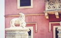 Traditional architecture of Sicily in Italy, typical street of Taormina, facade of old buildings with white marble monument of Royalty Free Stock Photo