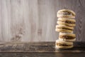 Traditional Argentinian alfajores with dulce de leche and sugar on wooden table