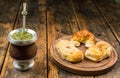 Traditional Argentinian yerba mate tea in calabash gourd and argentine pastries. Royalty Free Stock Photo