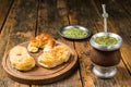 Traditional Argentinian yerba mate tea in calabash gourd and argentine pastries. Royalty Free Stock Photo