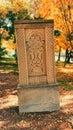 Traditional Armenian khachqar tuff cross stone in an sutumn park Royalty Free Stock Photo