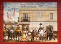 Traditional artwork on tile with colorful dressed women and horseride men on local festival of Andalusia