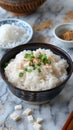 Traditional Asian Congee Rice Porridge Topped with Green Onions and Fried Garlic in Ceramic Bowl