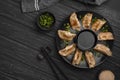 Traditional asian dumplings plate with chopsticks herbs. High quality and resolution beautiful photo concept Royalty Free Stock Photo