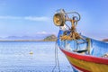 Traditional asian fishing boat sets nets for fishing in the sea against a blue sky with clouds on a sunny day. Royalty Free Stock Photo