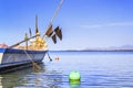 Traditional asian fishing boat sets nets for fishing in the sea against a blue sky with clouds on a sunny day. Royalty Free Stock Photo