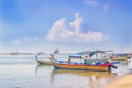 Traditional Asian fishing boats with nets parked off the coast before going fishing on a blue sky background with clouds Royalty Free Stock Photo