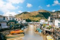 Traditional Asian Fishing Village and River under Blue Sky and Mountain in Hong Kong, China Royalty Free Stock Photo