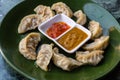 Traditional asian food. Nepalese steamed dumpling momo served with tomato chutney Royalty Free Stock Photo