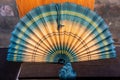 Traditional Asian handmade fan for sale in a shop window
