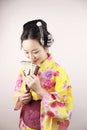 Traditional Asian Japanese beautiful Geisha woman wears kimono smile and hold a fan on hand on a white background Royalty Free Stock Photo