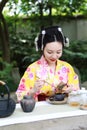 Traditional Asian Japanese beautiful woman show tea art green tea ceremony in outdoor garden Royalty Free Stock Photo