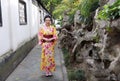 Traditional Asian Japanese woman bride Geisha wearing kimono play in a graden Royalty Free Stock Photo