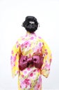 Traditional Asian Japanese woman with a figure viewed from behind on isolated white background