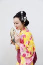 Traditional Asian Japanese woman with kimono with a fan on hand on isolated white background