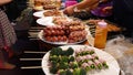 Traditional Asian night street food market in Thailand. Barbecue meatballs and other exotic delicious snacks for sail. Ready to