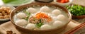 Traditional Asian Rice Porridge with Fish Balls, Ginger, and Green Onions in Ceramic Bowl
