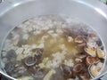 Traditional Asian soup, Steamed rising from a big pot of boiling shiitake mushrooms and mince pork balls soup on top of the stove Royalty Free Stock Photo