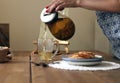 Traditional heral tea with glass teapot, cup, dried rose buds and pancaces . Flowers on wooden table at home background