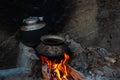 Traditional asian way to cook, old pot and kettle in fireplace Royalty Free Stock Photo