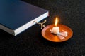 Traditional Atonement Day,worship with Holy Book and a candle on black