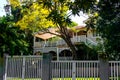 Traditional Australian Queenslander House with tropical foliage and wood and stairs