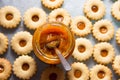 Traditional Austrian home baked Christmas cookies Linzer eyes with apricot jam on baking tray with glass jar and spoon