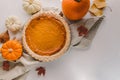 Traditional autumn food, pumpkin pie and colorful pumpkins Royalty Free Stock Photo