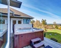 Traditional back deck with tall windows, and jacuzzi tub. Royalty Free Stock Photo